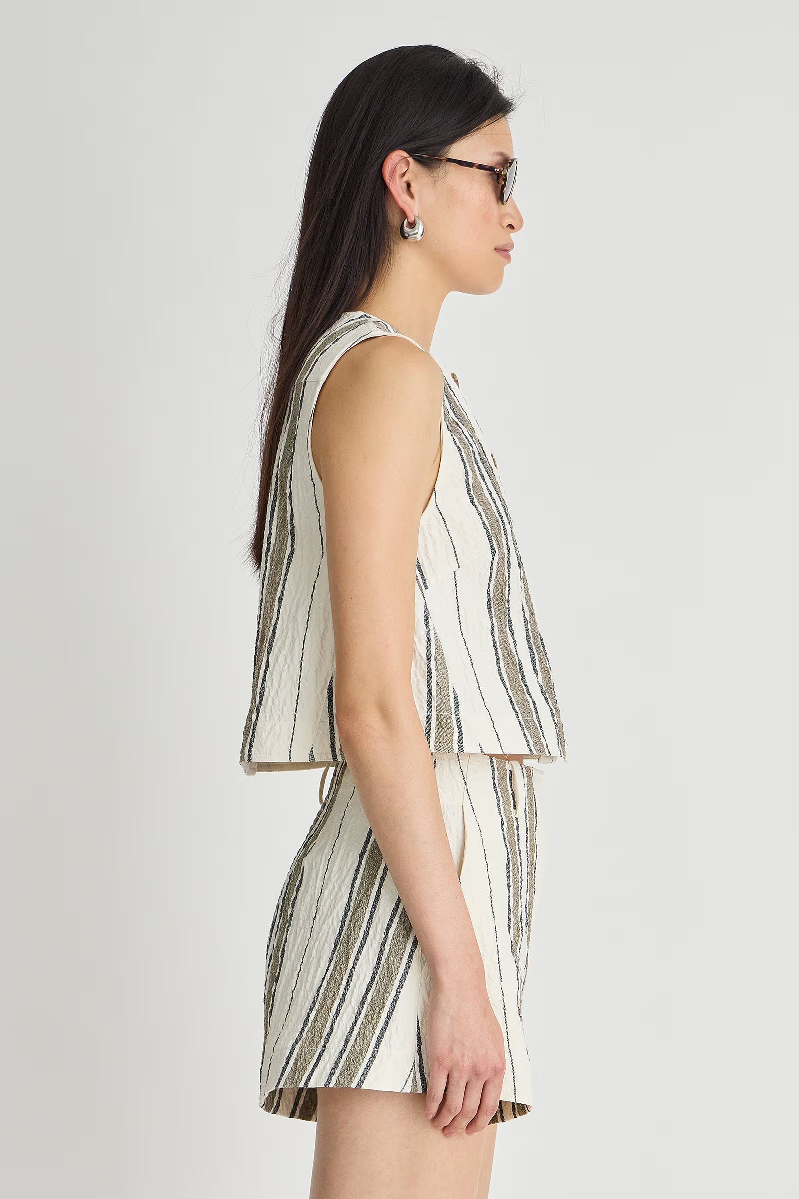 Woman wearing a striped dress on a white background