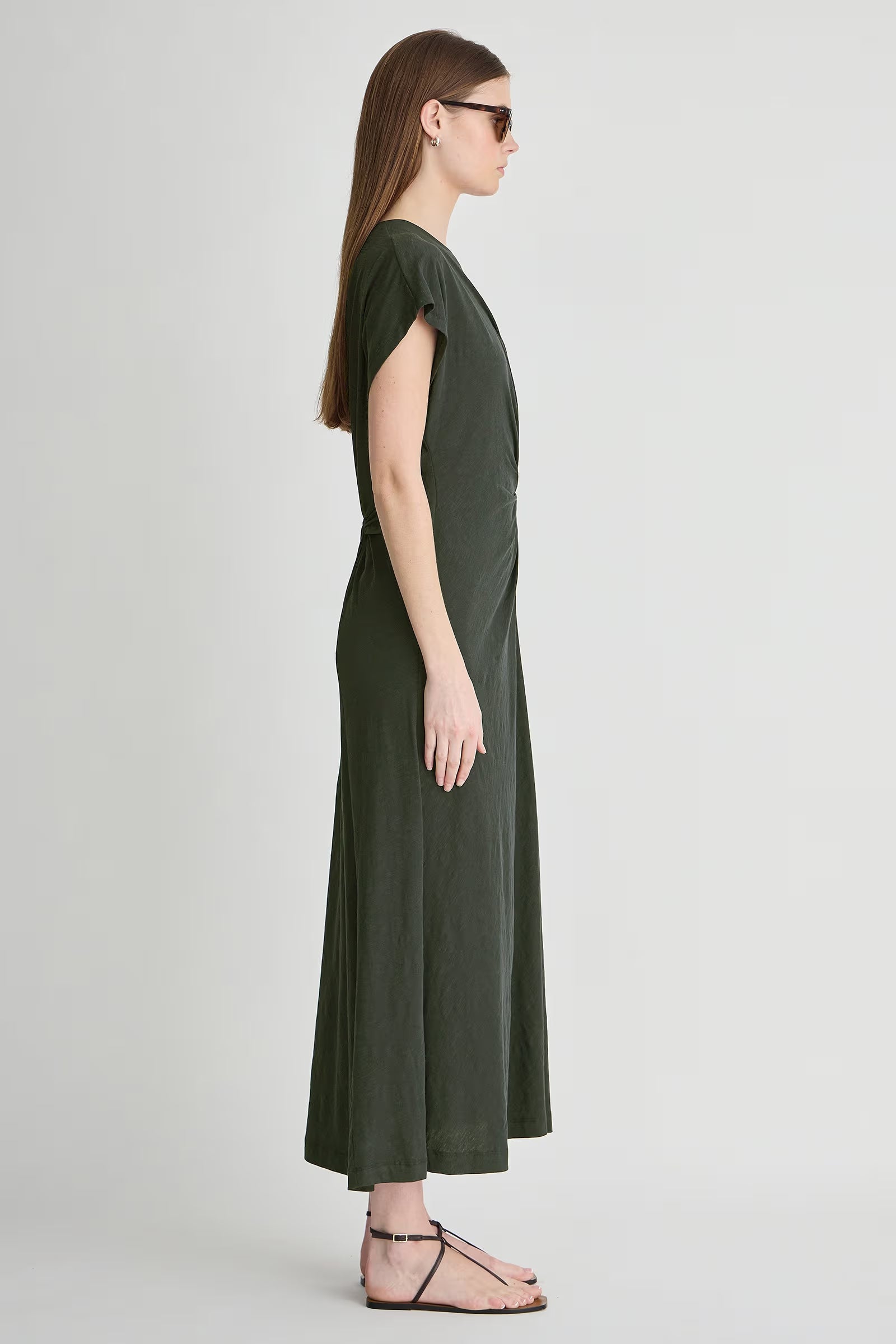 Woman wearing a green dress on a white background
