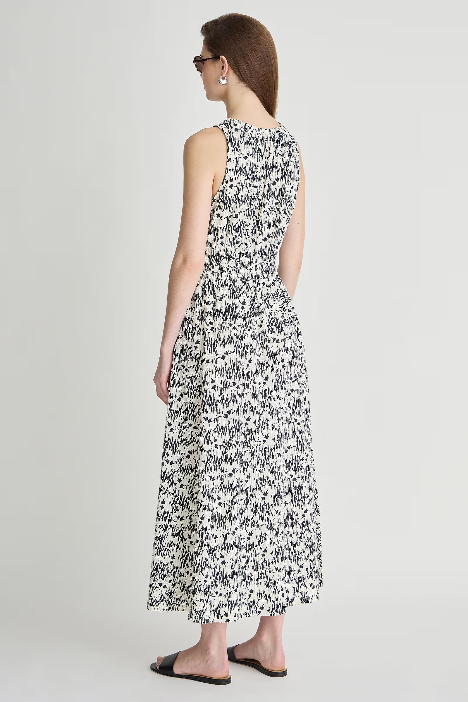 Woman wearing a floral dress on a plain background