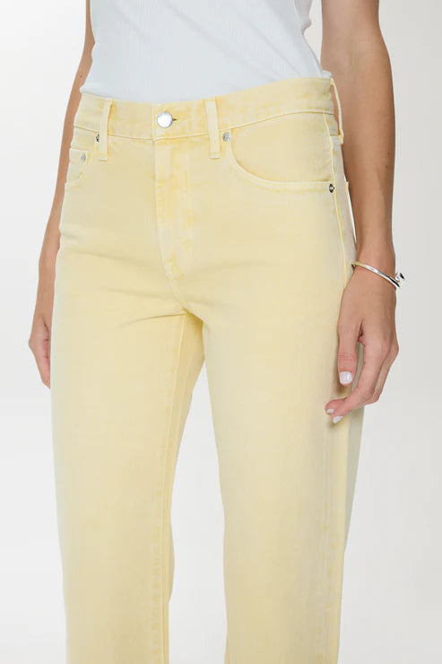 Yellow jeans worn by a person on a white background