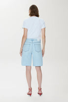 Person wearing light blue shorts and a white t-shirt on a white background