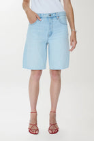Light blue denim shorts worn by a person on a white background