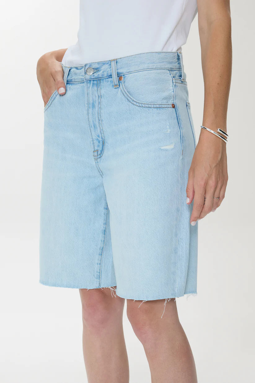 Light blue denim shorts worn by a person on a white background