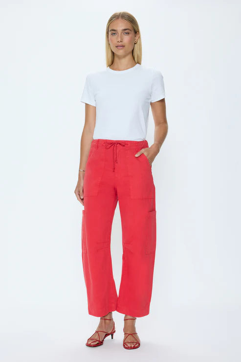 Woman wearing a white t-shirt and red pants on a white background