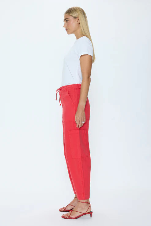 Woman wearing a white t-shirt and red pants on a white background