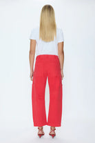 Person wearing a white t-shirt and red pants on a white background
