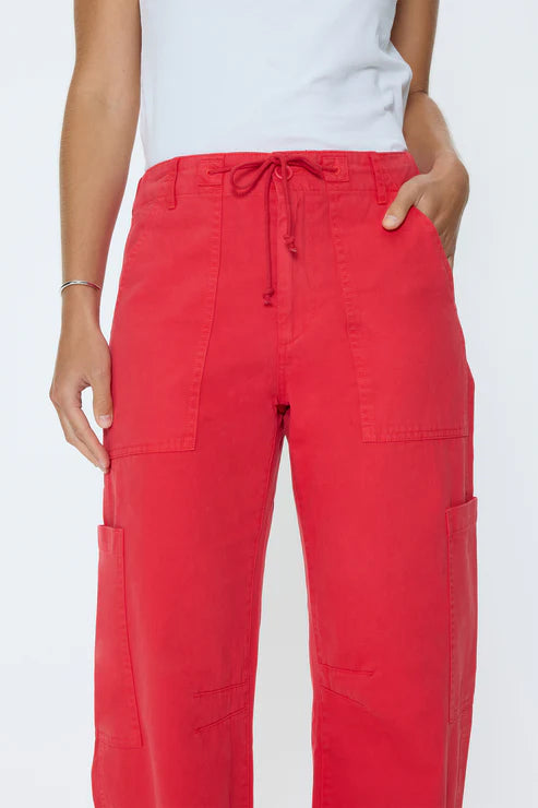 Red cargo pants worn by a person on a white background