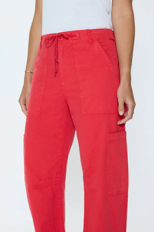 Red pants worn by a person on a white background
