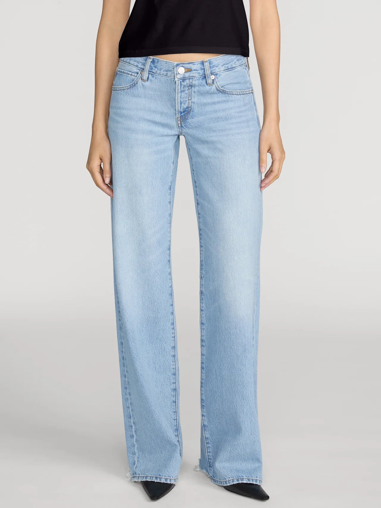 Light blue jeans worn by a person on a white background