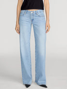 Light blue jeans worn by a person on a white background