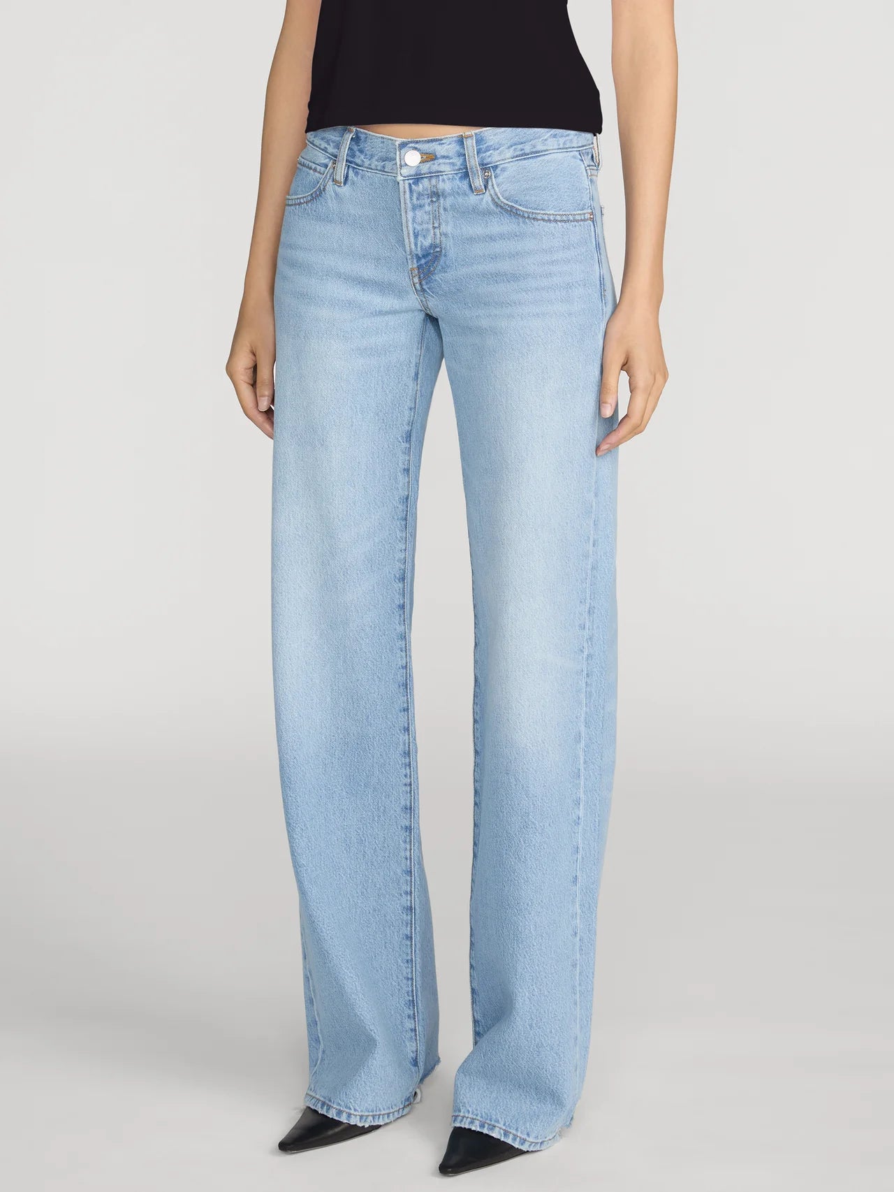 Light blue jeans worn by a person on a white background