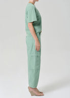 Person wearing a mint green outfit on a white background