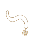 Gold necklace with a white flower pendant on a white background
