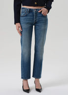 Person wearing blue jeans on a white background