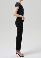 Person wearing a black outfit with a plain background
