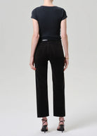 Person wearing a black t-shirt and black pants on a white background