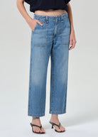 Person wearing blue jeans on a white background