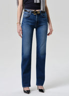 Person wearing blue jeans with a white background