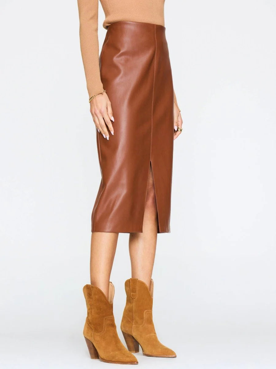 Brown leather skirt worn by a person on a white background