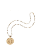 Gold necklace with a round pendant on a white background