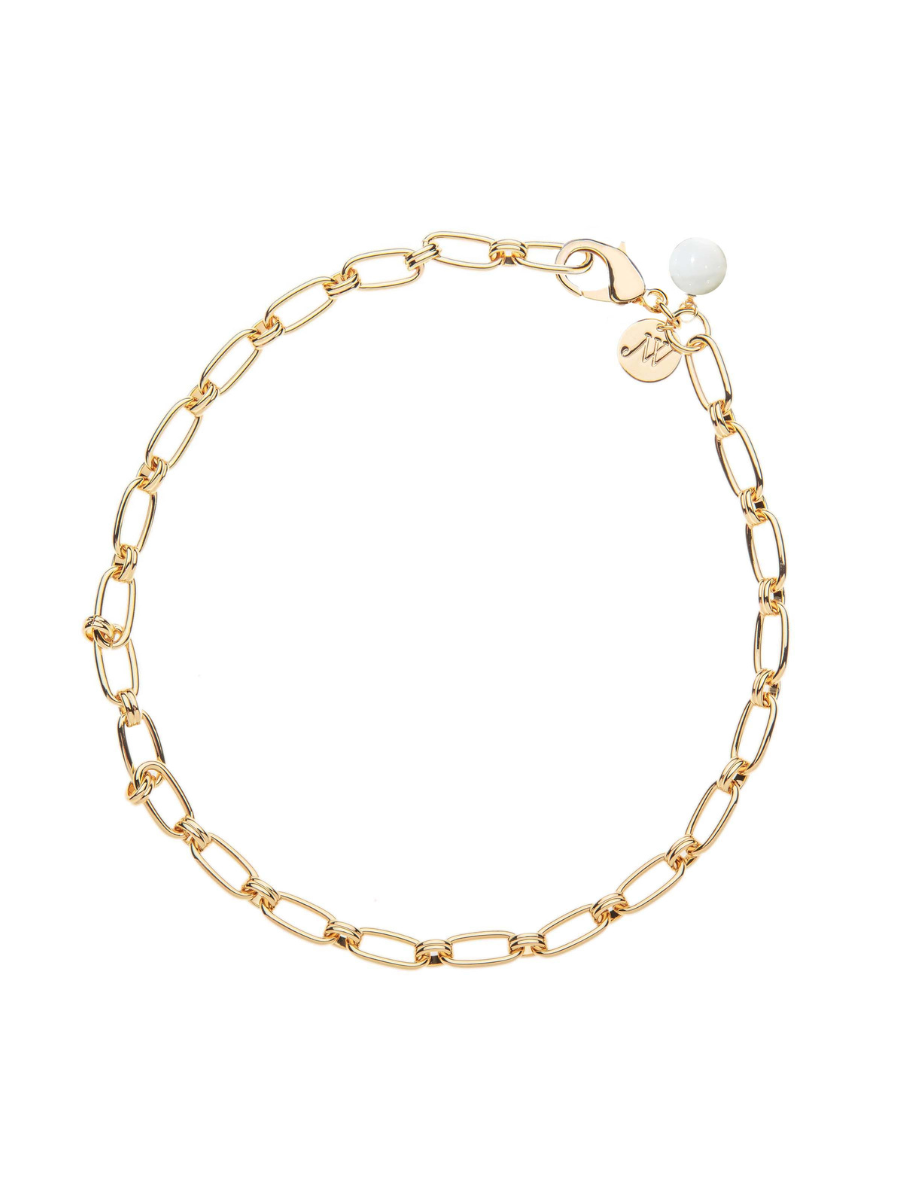 Gold chain bracelet with a pearl on a white background