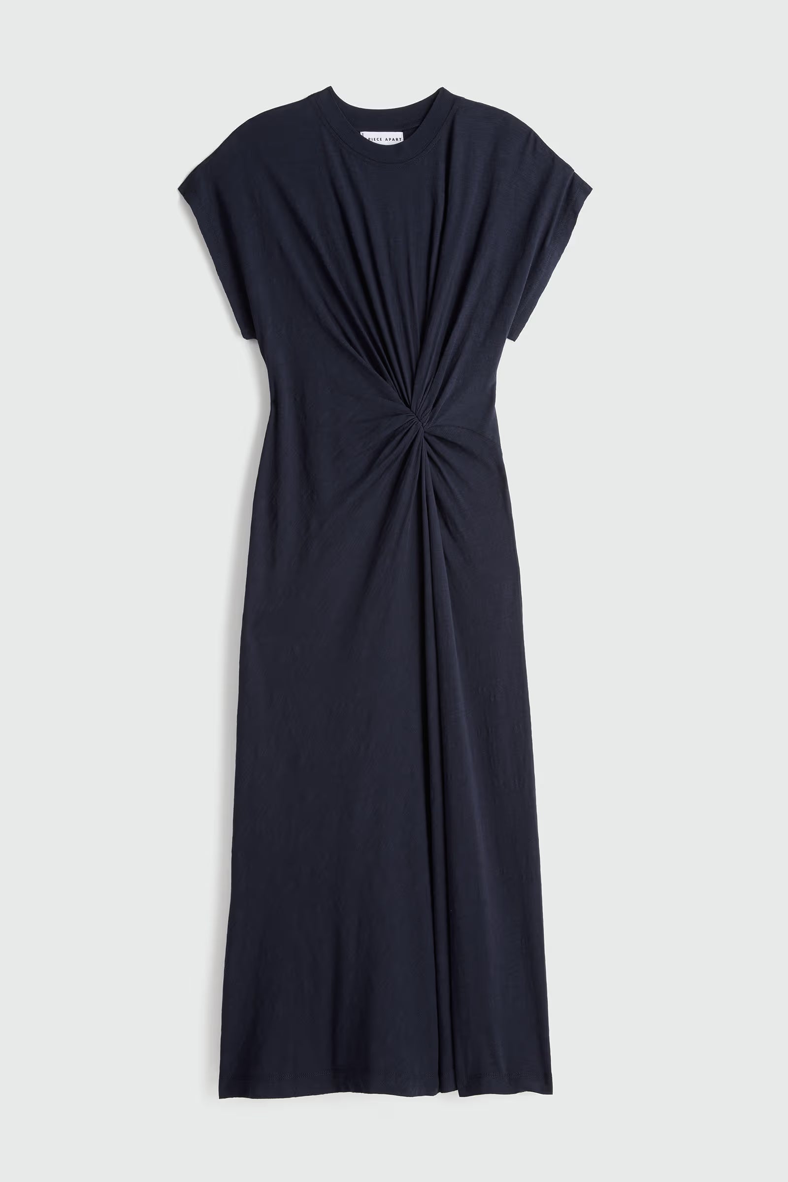 Black dress with a knot detail on a light gray background