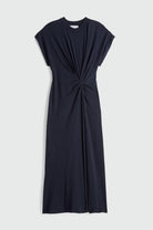 Black dress with a knot detail on a light gray background