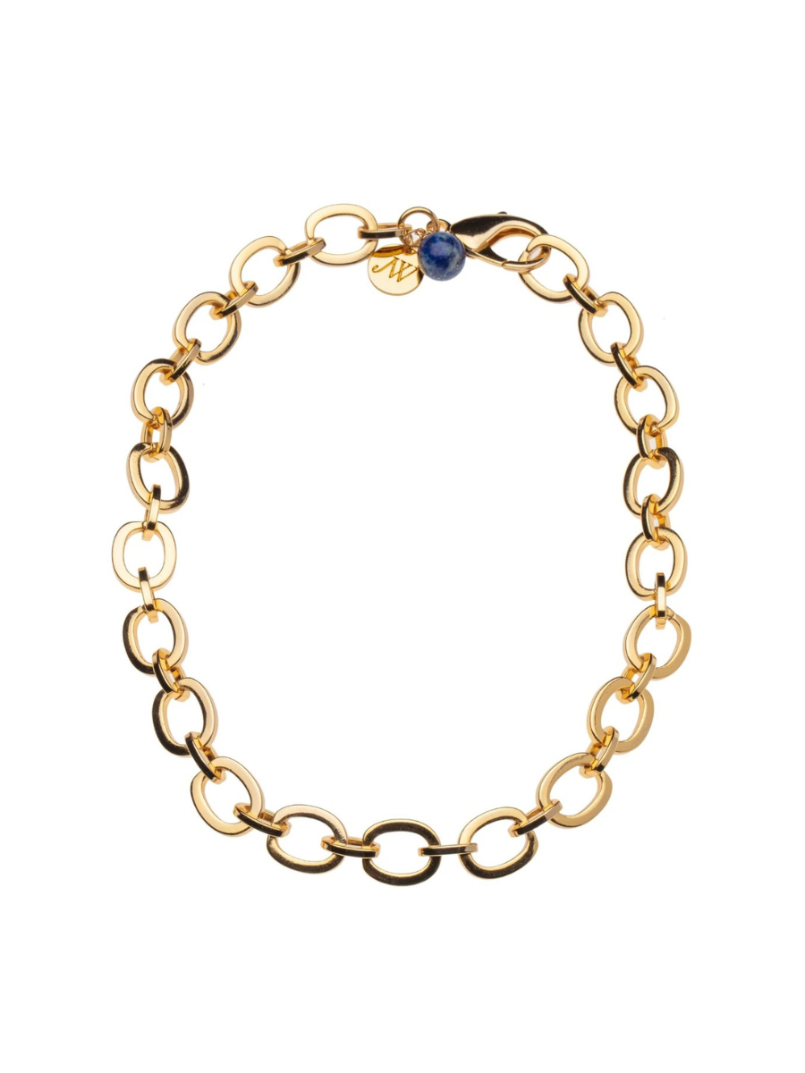 Gold chain bracelet with a blue gemstone on a white background