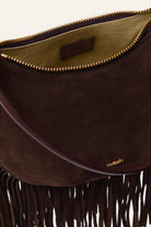 Brown suede handbag with fringe detail and visible brand logo on a white background