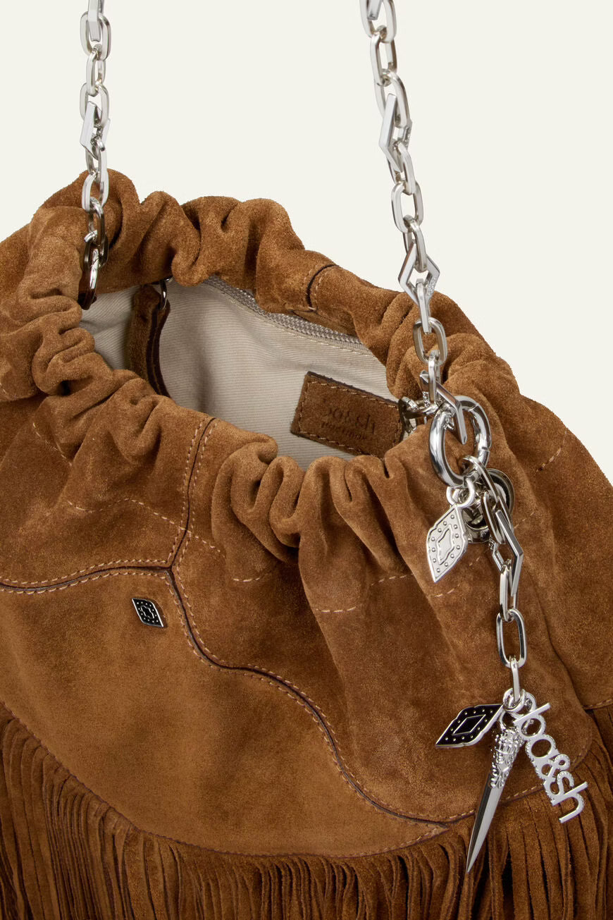 Brown suede handbag with fringes and chain strap on a light gray background