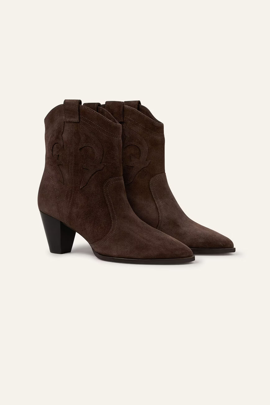 Pair of brown suede cowboy boots on a white background