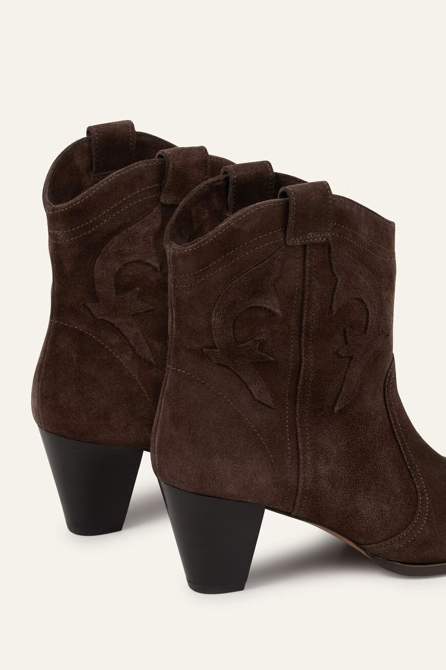 Pair of brown suede ankle boots with black soles on a white background