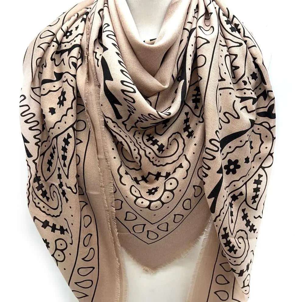 Beige scarf with black pattern on a mannequin against a white background
