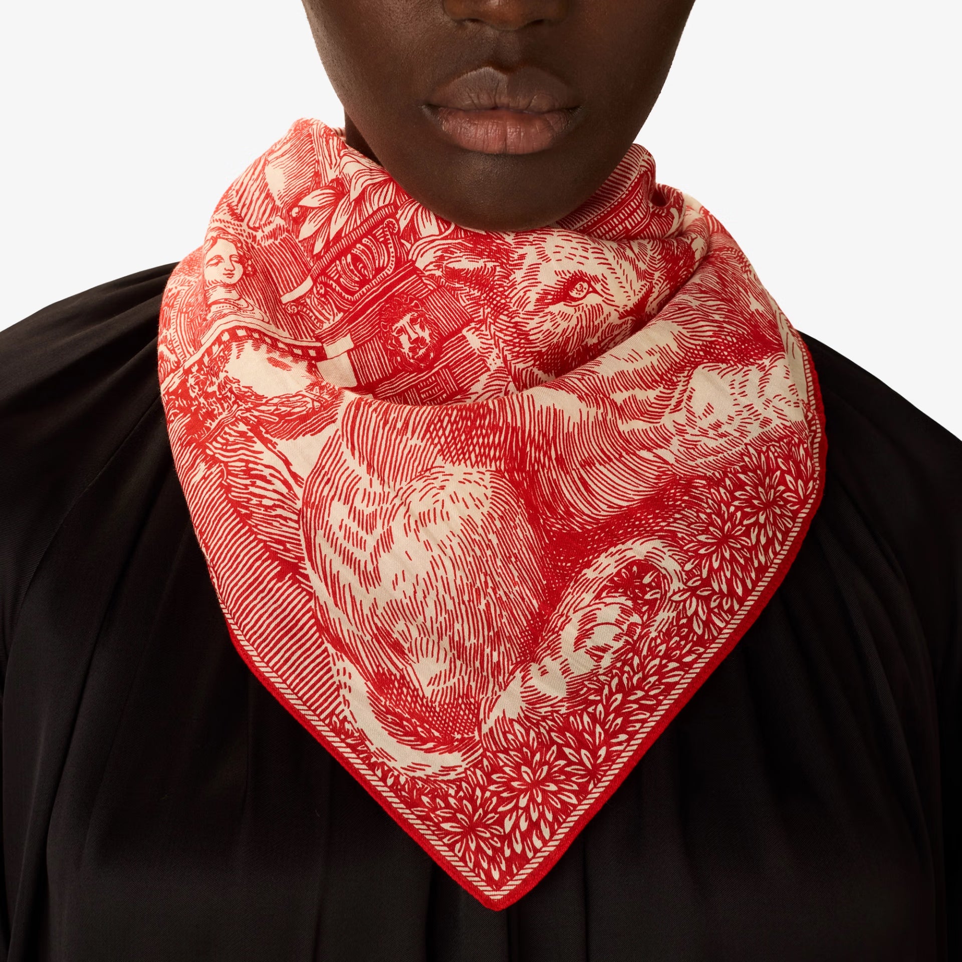 Person wearing a red and white patterned scarf on a black background