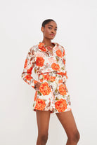 Woman wearing a floral outfit on a white background
