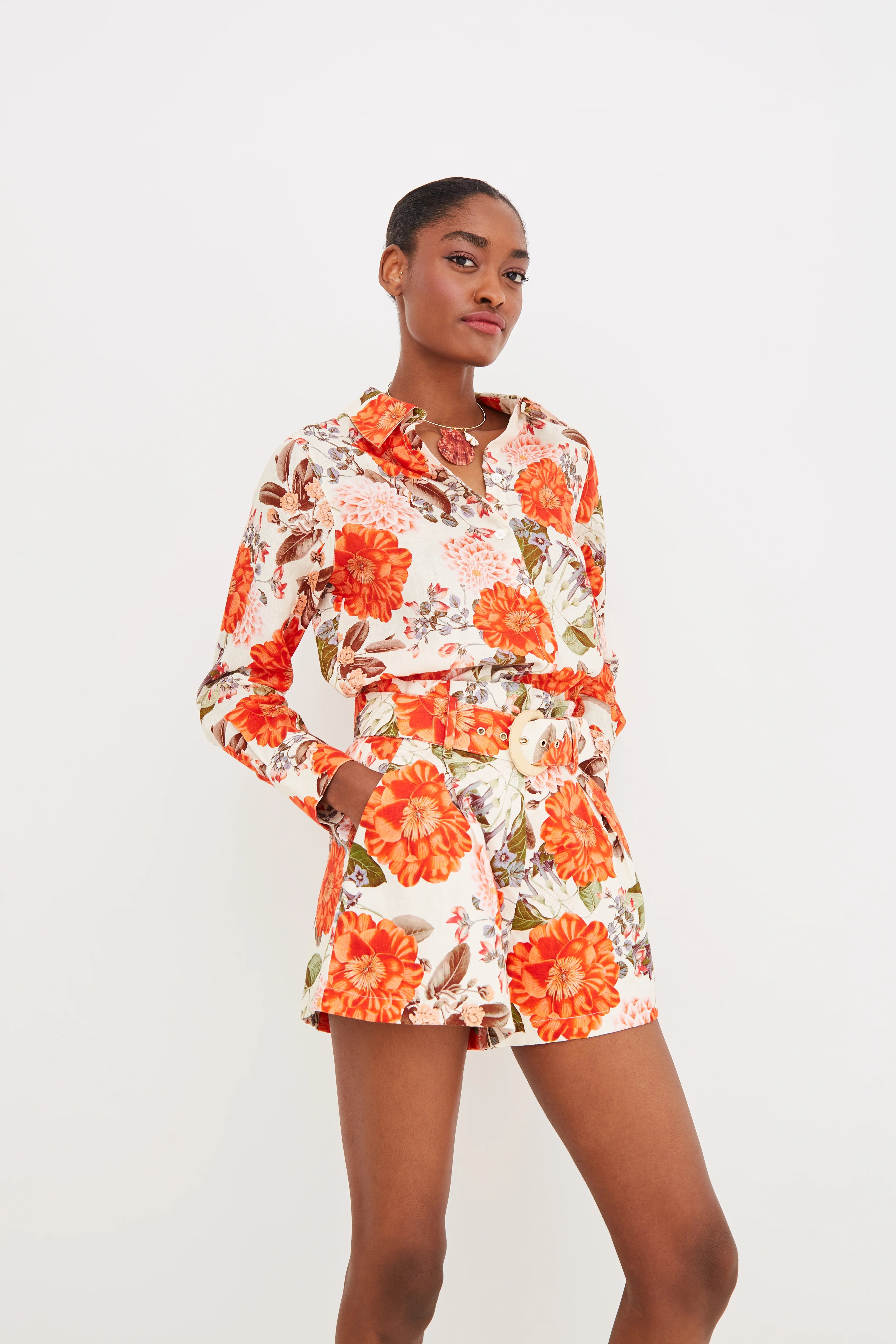 Woman wearing a floral outfit on a white background