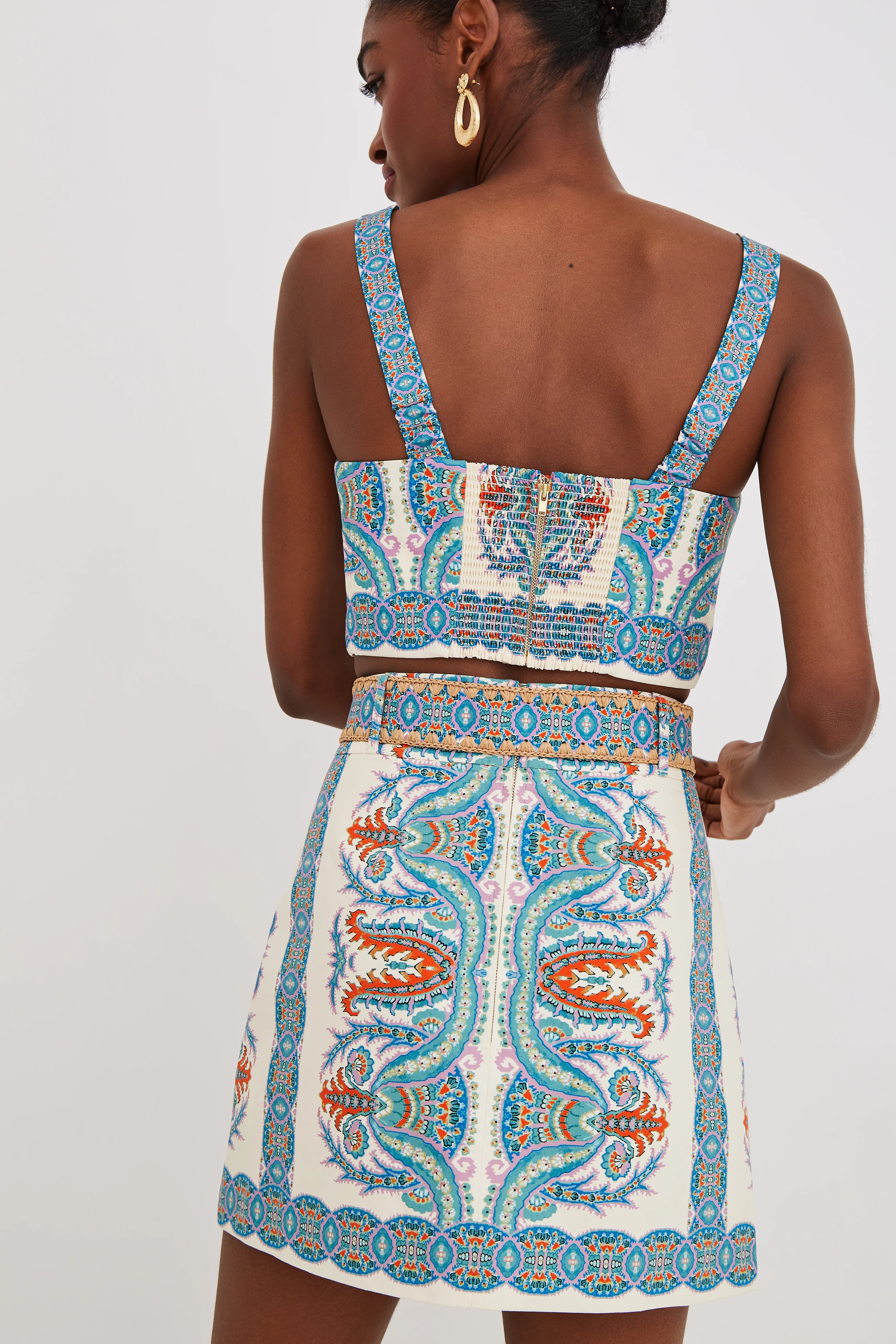 Woman wearing a patterned dress with a white background