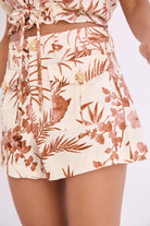 Floral patterned shorts worn by a person on a white background