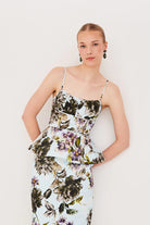 Woman wearing a floral dress against a white background