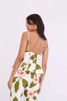 Woman wearing a floral dress with a white background
