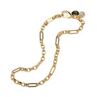 Gold chain bracelet with a heart charm on a white background