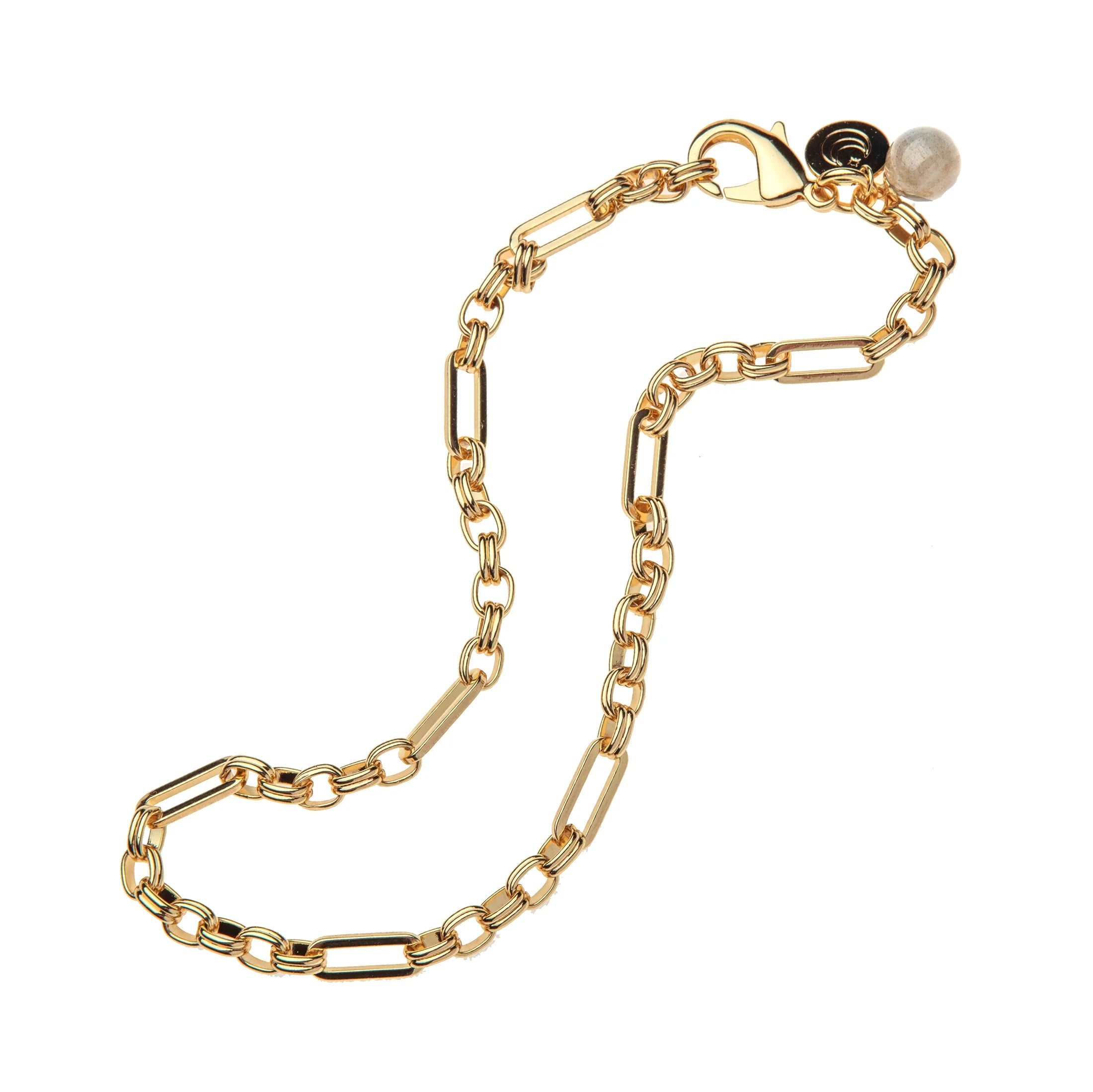Gold chain bracelet with a heart charm on a white background