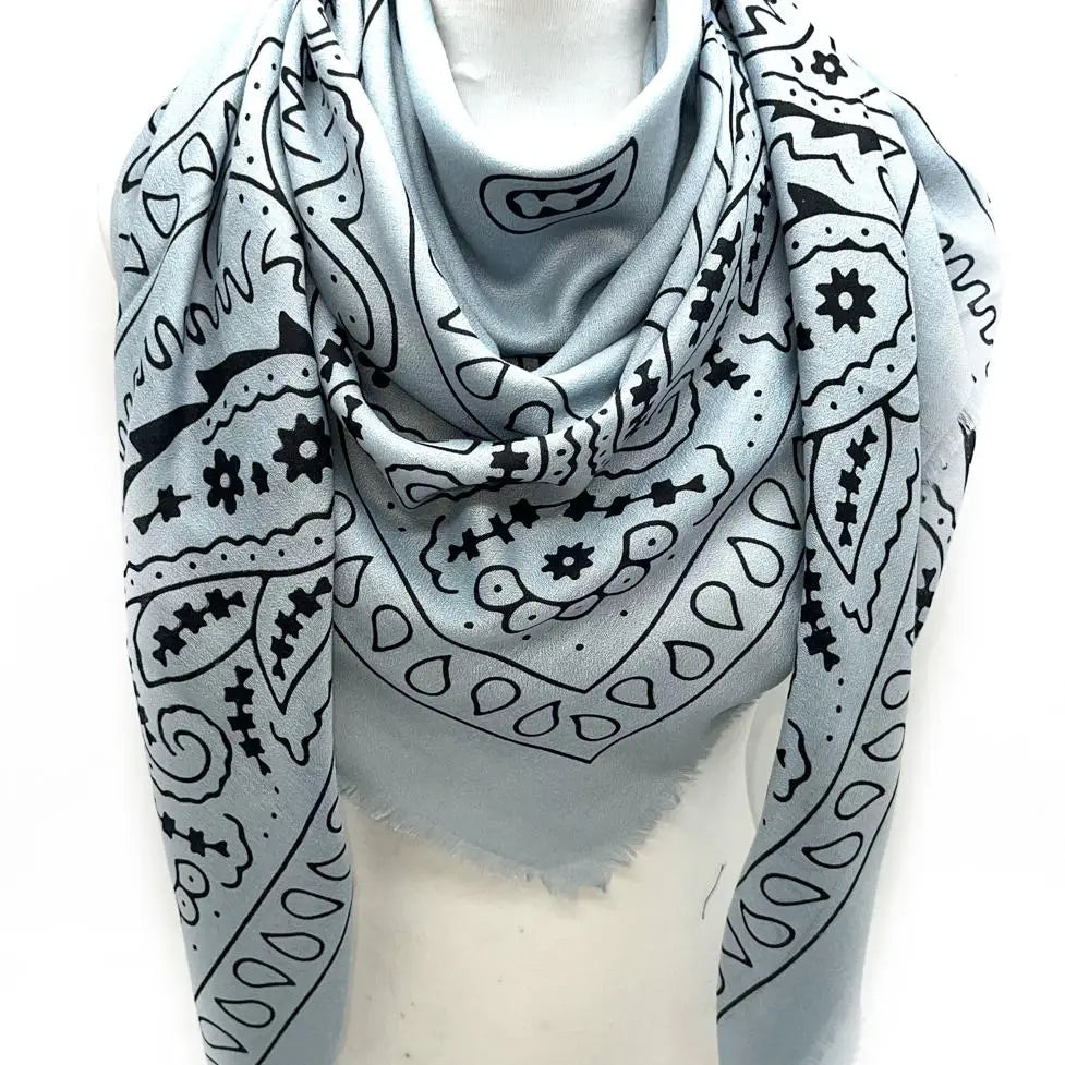Gray scarf with black abstract patterns on a mannequin against a white background
