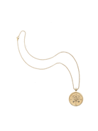 Gold necklace with a round pendant on a white background