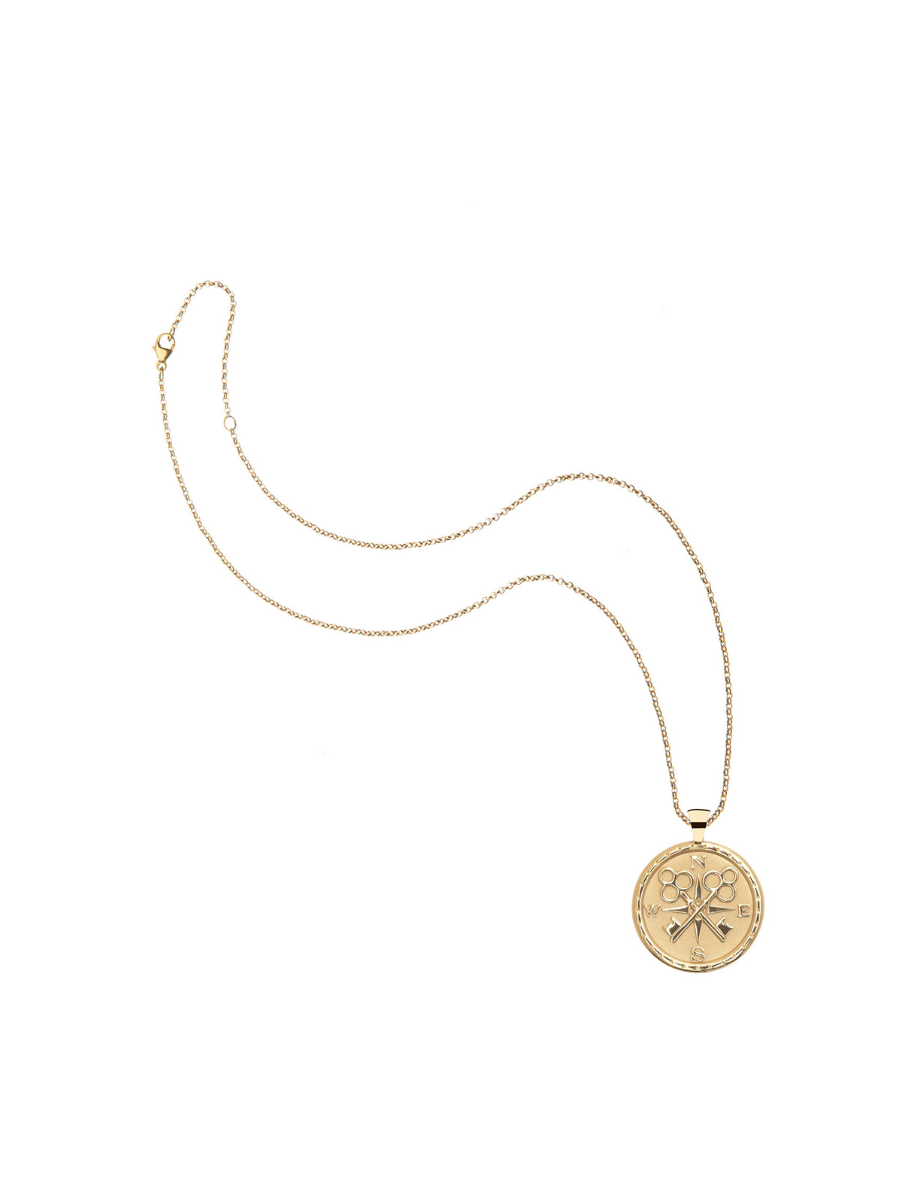 Gold necklace with a round pendant on a white background