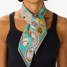 Person wearing a colorful scarf with decorative patterns on a white background