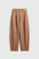 A pair of relaxed-fit trousers in a warm tan or camel color, featuring a pleated front and side pockets, laid flat against a light gray background.