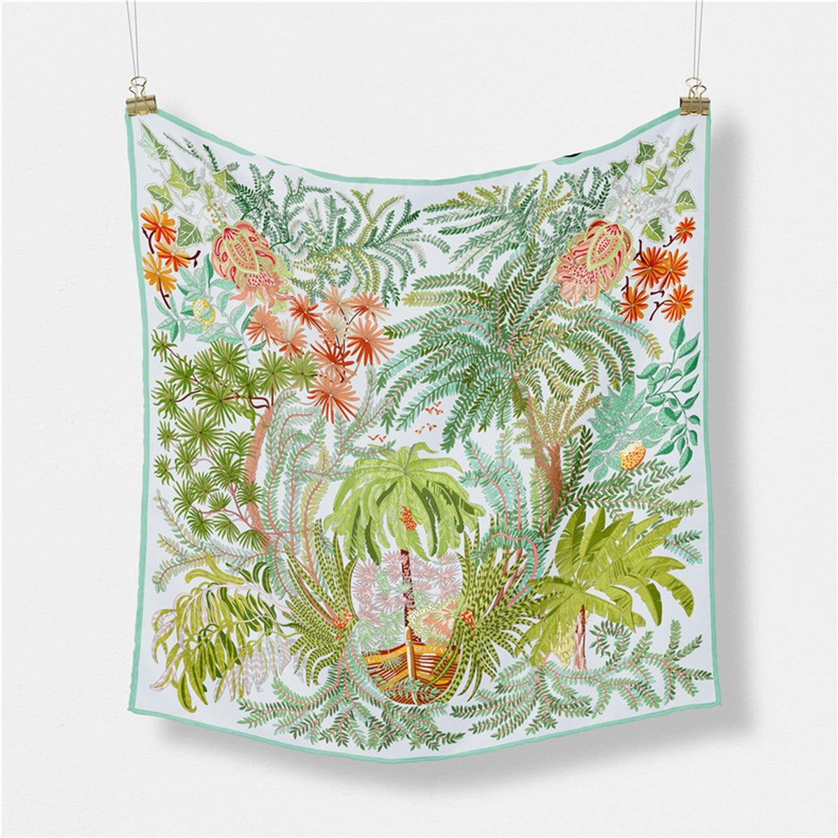 Tropical leaf patterned fabric hanging on a white background