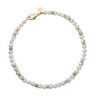 Pearl bracelet with gold accents on a white background
