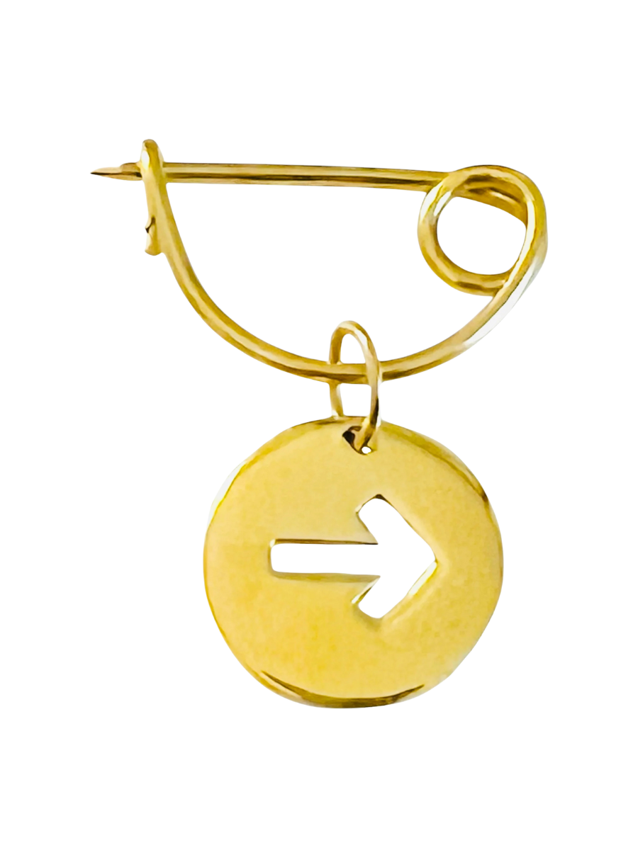 Gold-colored brooch with a circular design featuring an arrow symbol on a white background
